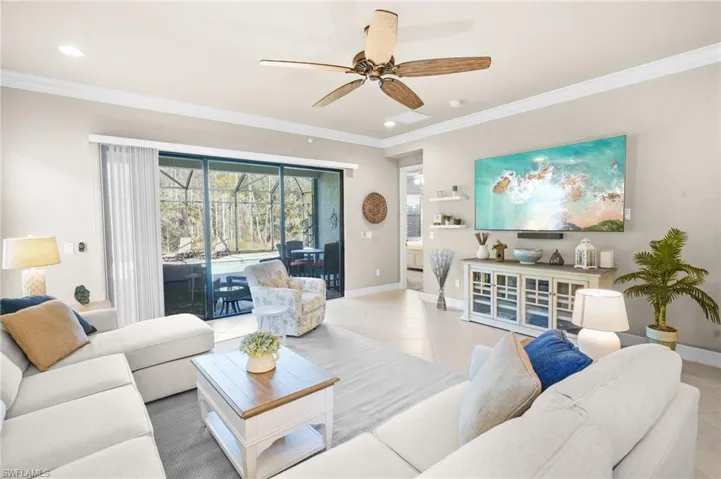 Living room featuring ornamental molding, tile patterned floors, ceiling fan, and recessed lighting