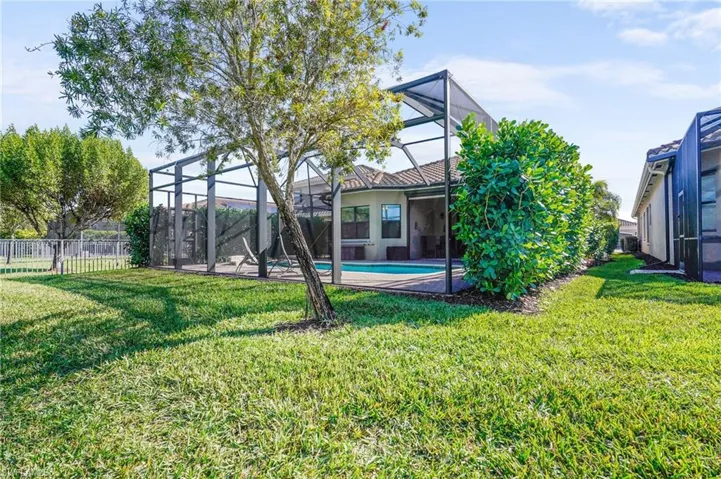 Back of house featuring a sunroom, a patio area, and glass enclosure
