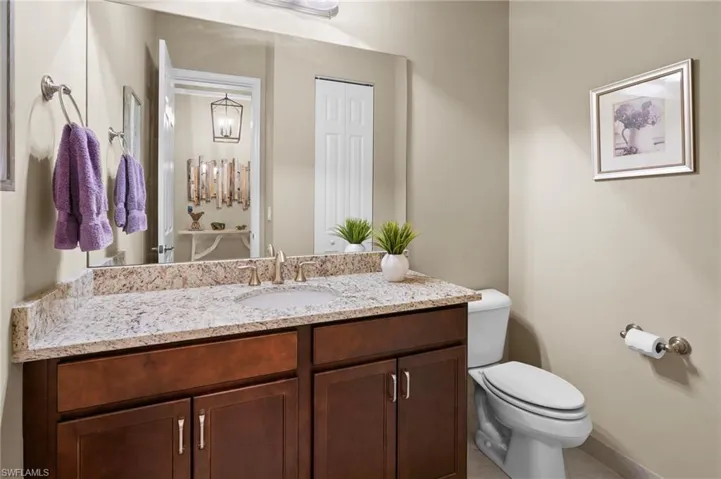 Half bathroom featuring vanity and toilet