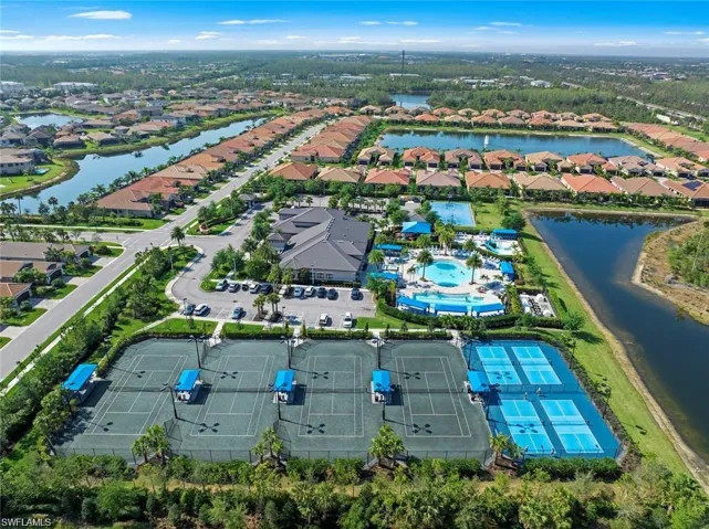 Aerial view of residential area featuring a nearby body of water