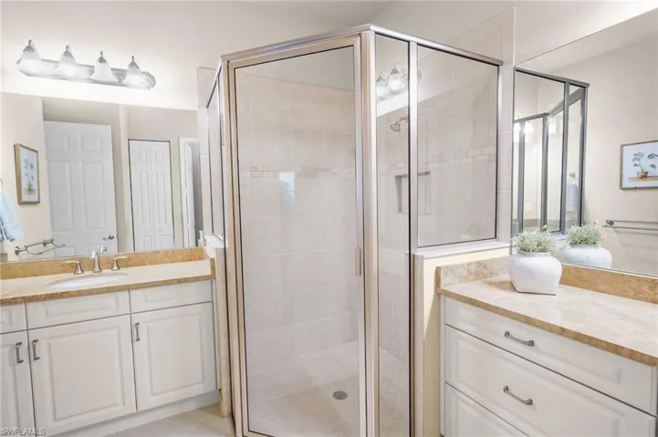 Full bathroom with vanity and a shower stall