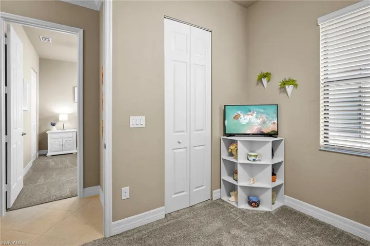 Game room featuring light carpet and light tile patterned floors