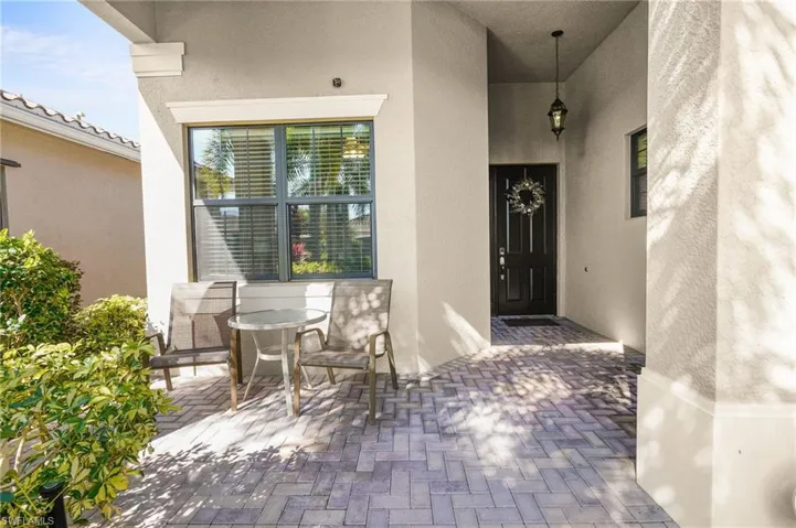 Entrance to property featuring a patio area and stucco siding