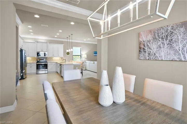 Dining area featuring ornamental molding, recessed lighting, and light tile patterned floors