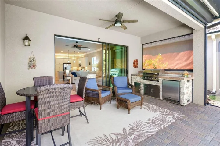 View of patio / terrace with an outdoor kitchen, ceiling fan, outdoor lounge area, and outdoor dining area