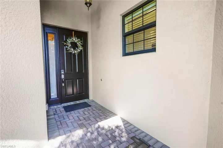 Property entrance with stucco siding