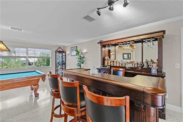 Was once a formal living room now a entertainment area leading out to the pool area