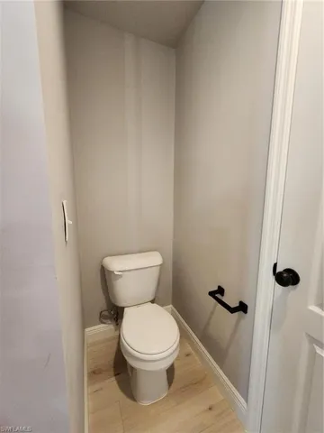 Bathroom featuring wood-type flooring and toilet