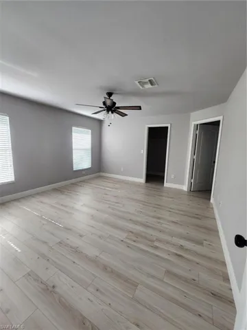 Unfurnished bedroom featuring ceiling fan and light wood-type flooring
