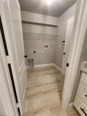 Laundry room featuring hookup for an electric dryer, hookup for a washing machine, gas dryer hookup, and light hardwood / wood-style floors