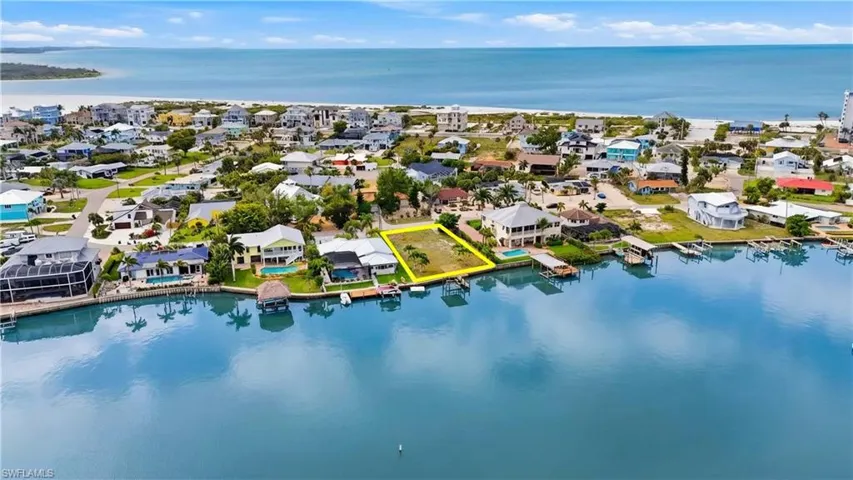 Aerial view of residential area featuring a nearby body of water - Virtually Edited Image