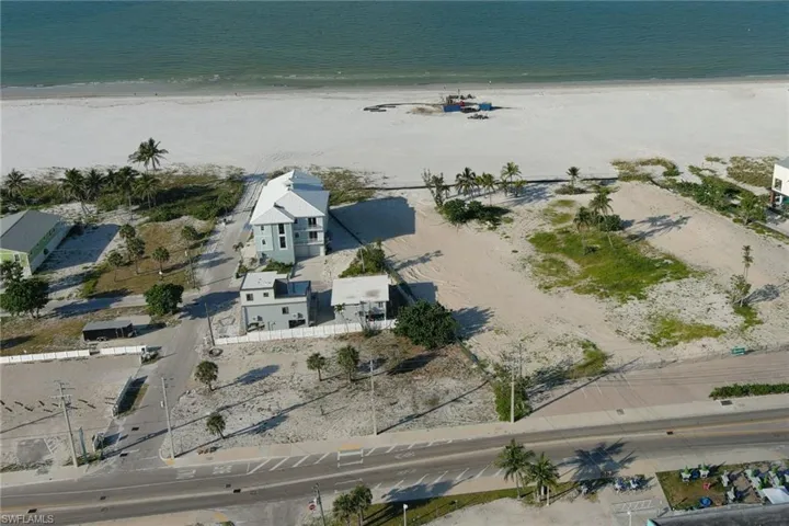 Aerial overview of property's location featuring extended coastline