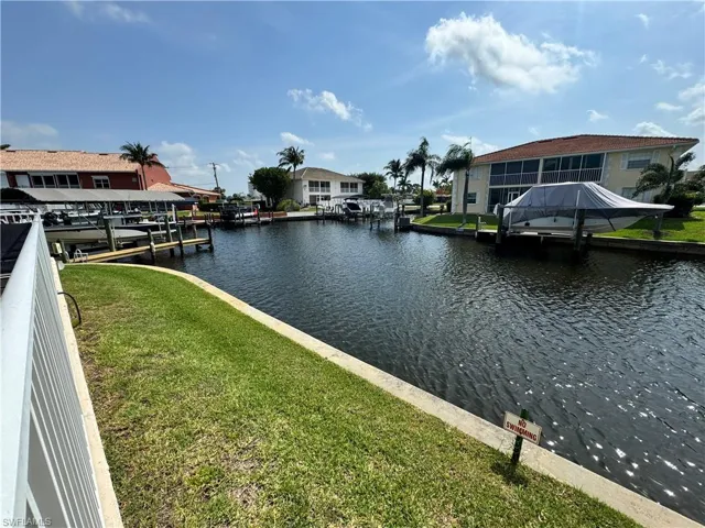 Dock area featuring a lawn and a water view