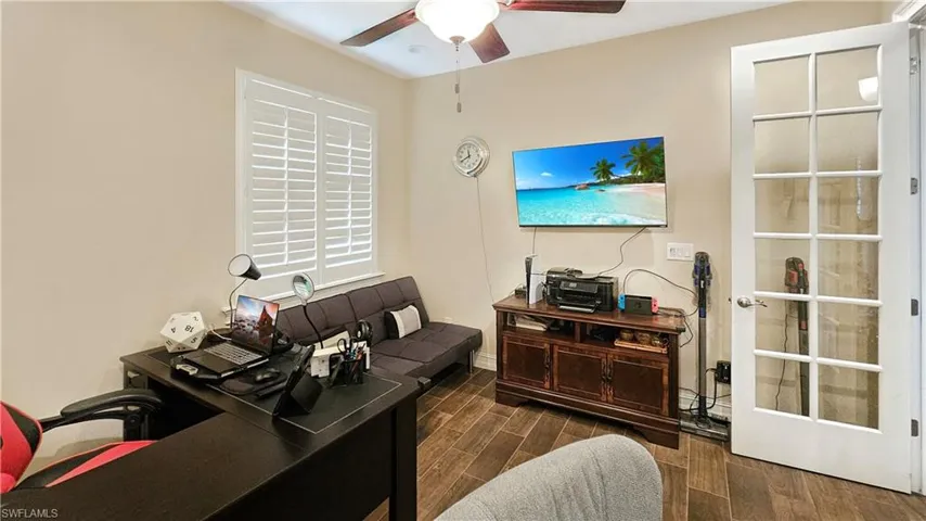 Office space featuring ceiling fan and dark wood-type flooring