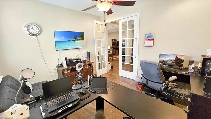 Office area featuring ceiling fan, french doors, and hardwood / wood-style floors