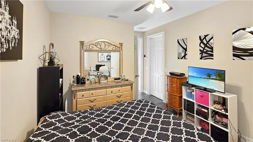 Bedroom featuring dark hardwood / wood-style floors and ceiling fan