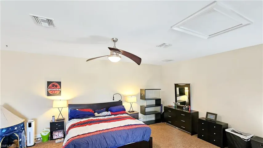 Carpeted bedroom with ceiling fan