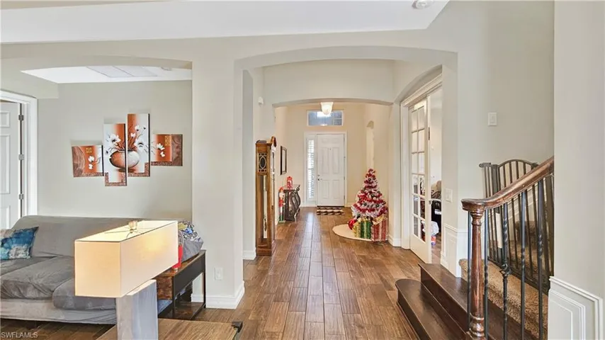 Foyer entrance with hardwood / wood-style floors