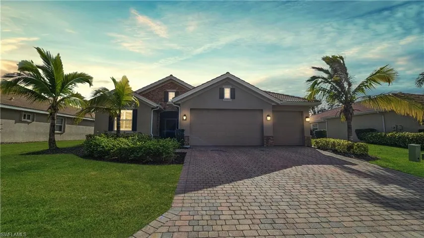 View of front of home featuring a lawn and a garage