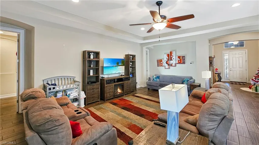 Living room featuring wood-type flooring and ceiling fan