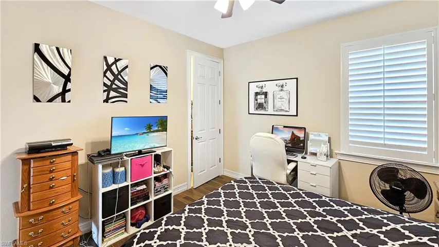 Home office featuring dark hardwood / wood-style floors, plenty of natural light, and ceiling fan