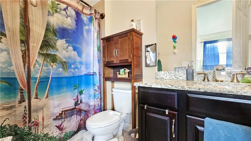 Bathroom for loft featuring vanity and toilet