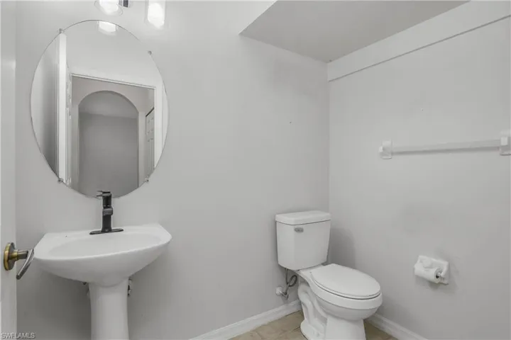 Bathroom featuring toilet and light tile patterned floors