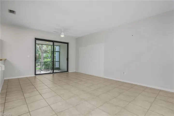 Spare room with ceiling fan and light tile patterned floors
