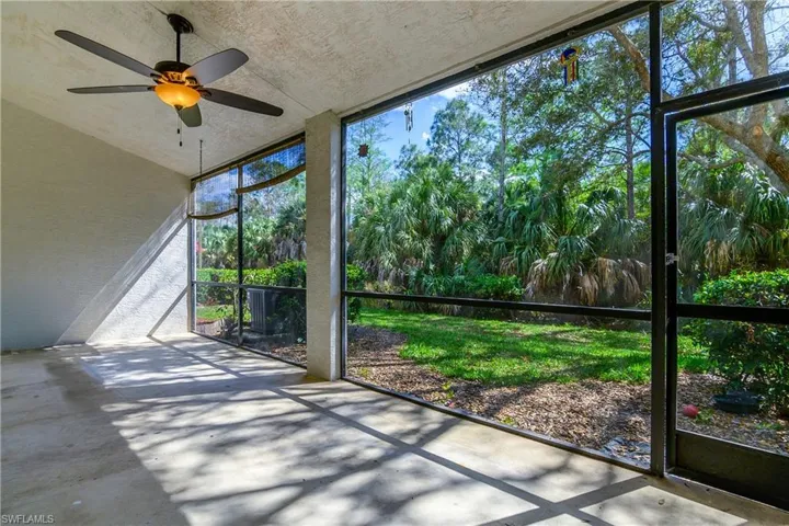 Unfurnished sunroom with ceiling fan