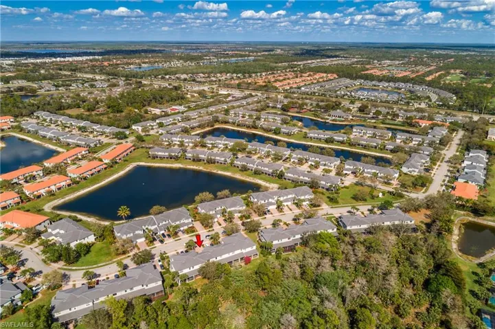 Aerial perspective of suburban area with a nearby body of water