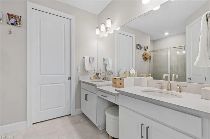Bathroom featuring tile patterned flooring and dual vanity