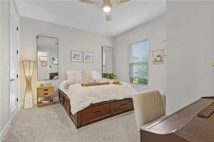 Carpeted bedroom with ceiling fan