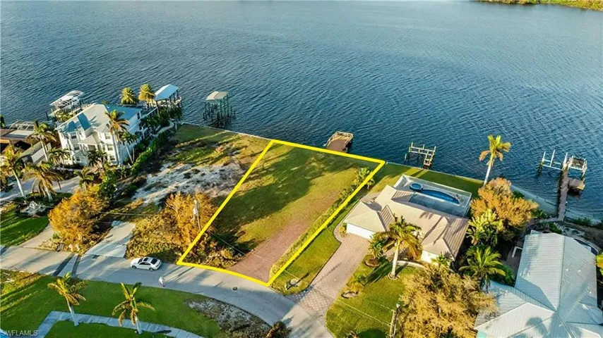 Prime waterfront lot offering an exceptional opportunity to build your dream home with direct water access - Virtually Edited Image