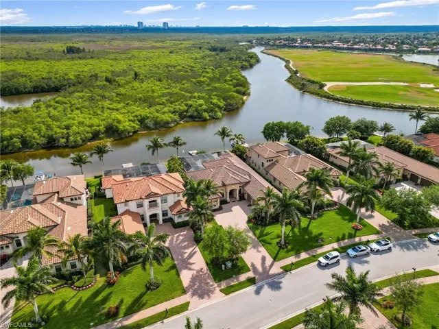 Aerial perspective of suburban area featuring a nearby body of water