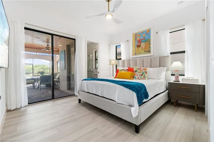 Bedroom featuring access to outside, light wood finished floors, and ceiling fan