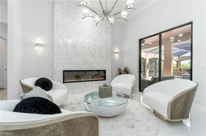Living room with a chandelier and a large fireplace