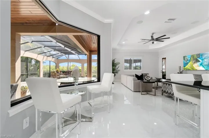 Dining area with ornamental molding, marble tiled flooring, ceiling fan, and recessed lighting