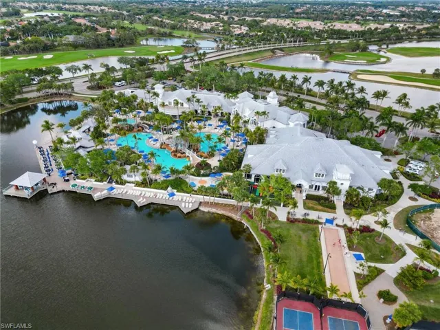 Aerial view of property's location with a large body of water and nearby suburban area