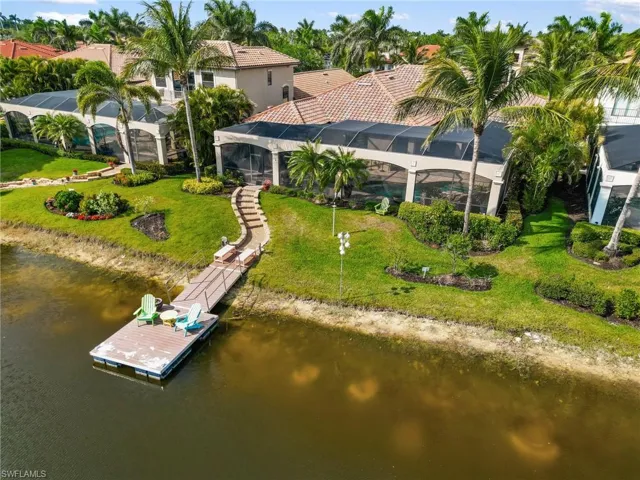 Aerial view of property and surrounding area featuring a nearby body of water
