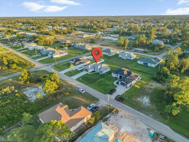 Aerial view of property's location with nearby suburban area