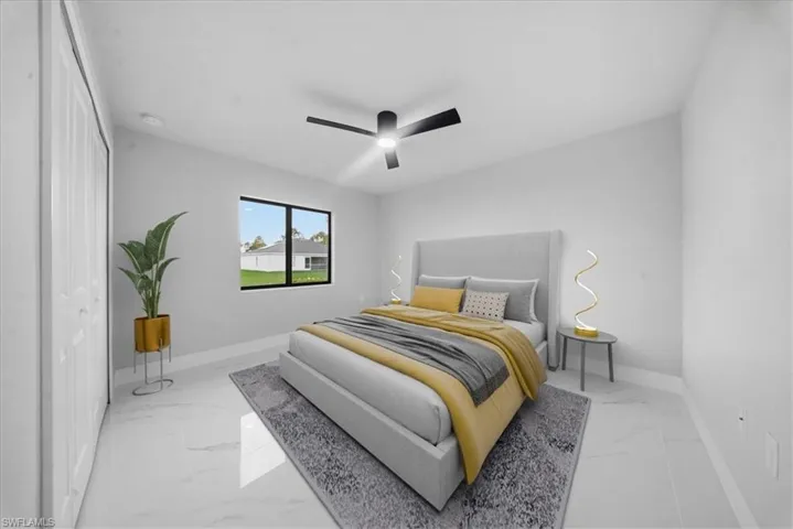 Bedroom featuring ceiling fan, marble finish flooring, and a closet
