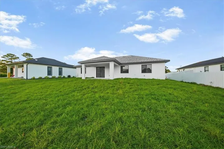Rear view of property with stucco siding