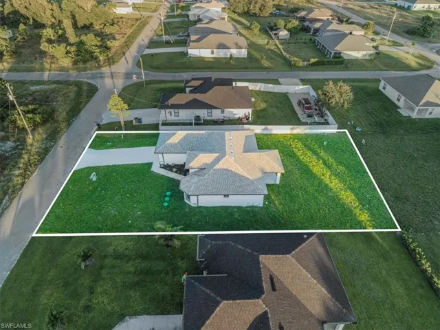 Aerial view of residential area featuring property boundaries highlighted
