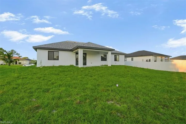Rear view of property with a patio area and stucco siding