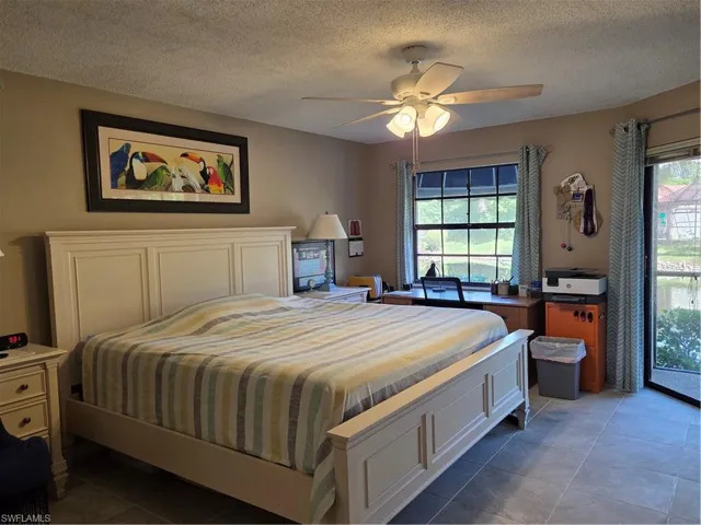 Spacious primary bedroom with water view.