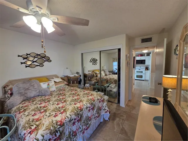Spacious guest bedroom with ceiling fan.