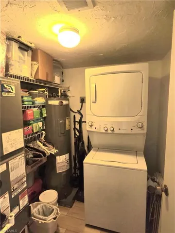 Laundry room provides extra storage, along with washer, dryer, & water heater.