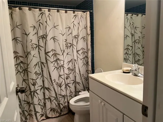 Full bathroom with vanity and a shower with shower curtain