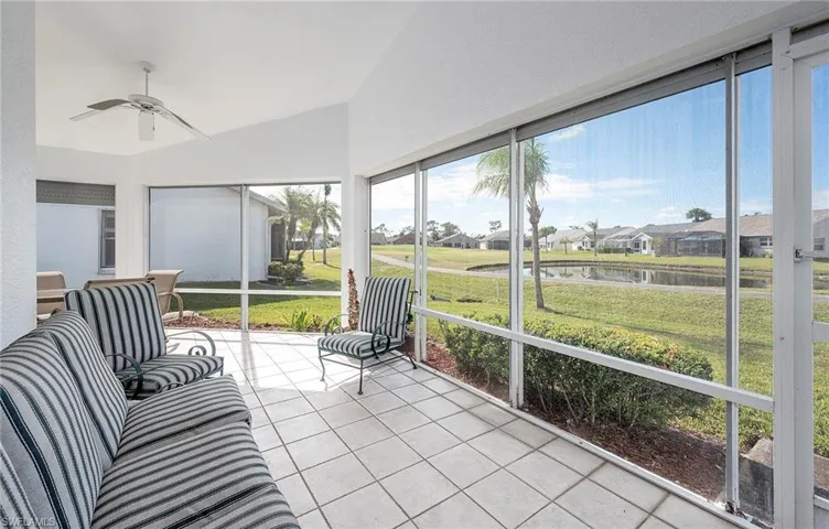 Outdoor living on the Sunroom featuring golf and a water view