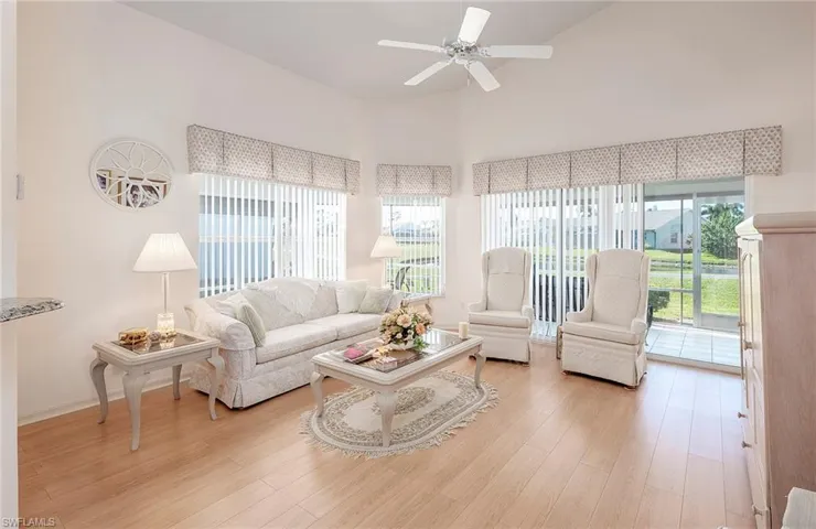 Living room with ceiling fan, high ceiling